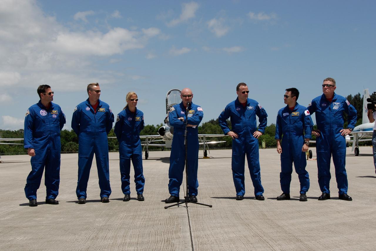 CAPE CANAVERAL, Fla. -- After their arrival on the Shuttle Landing Facility at NASA's Kennedy Space Center, the crew members of space shuttle Discovery's STS-124 mission gather to talk to the media. From left are Mission Specialist Gregory Chamitoff, Pilot Ken Ham, Mission Specialist Karen Nyberg, Commander Mark Kelly, and Mission Specialists Ron Garan, Akihiko Hoshide and Mike Fossum. Hoshide represents the Japan Aerospace Exploration Agency. Launch of Discovery is scheduled for 5:02 p.m. May 31. On the STS-124 mission, the crew of seven will deliver and install the Japanese Experiment Module – Pressurized Module and Japanese Remote Manipulator System. Photo credit: NASA/Kim Shiflett