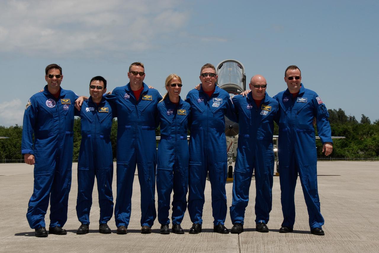 CAPE CANAVERAL, Fla. -- After their arrival on the Shuttle Landing Facility at NASA's Kennedy Space Center, the crew members of space shuttle Discovery's STS-124 mission pose for a group photo. From left are Mission Specialists Gregory Chamitoff and Akihiko Hoshide, Pilot Ken Ham, Mission Specialists Karen Nyberg and Mike Fossum, Commander Mark Kelly and Mission Specialist Ron Garan. Launch of Discovery is scheduled for 5:02 p.m. May 31. On the STS-124 mission, the crew of seven will deliver and install the Japanese Experiment Module – Pressurized Module and Japanese Remote Manipulator System. Photo credit: NASA/Kim Shiflett