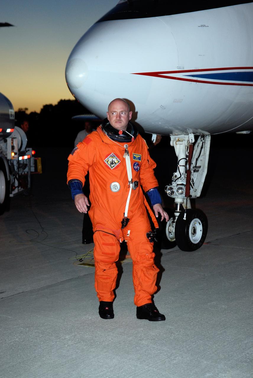 CAPE CANAVERAL, Fla. -- On the Shuttle Landing Facility at NASA's Kennedy Space Center, STS-124 Commander Mark Kelly walks away from the shuttle training aircraft after landing practice. The STA is a Grumman American Aviation-built Gulf Stream II jet that was modified to simulate an orbiter's cockpit, motion and visual cues, and handling qualities. In flight, the aircraft duplicates the orbiter's atmospheric descent trajectory from approximately 35,000 feet altitude to landing on a runway. Space shuttle Discovery is scheduled to lift off on the STS-124 mission at 5:02 p.m. May 31. Photo credit: NASA/Kim Shiflett