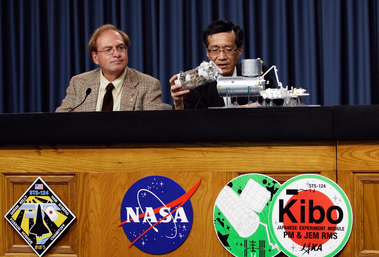 CAPE CANAVERAL, Fla. --    At a Japan Aerospace Exploration Agency briefing, Japanese Experiment Module Program Manager Yoshiyuki Hasegawa (right) explains how the Japanese Experiment Module – Pressurized Module will fit with the other segments on the International Space Station.  The final segment of the Kibo laboratory will be delivered to the space station on the STS-124 mission, which is scheduled to launch May 31.  NASA spokesman George Diller is at left.  Photo credit:  NASA/Kim Shiflett
