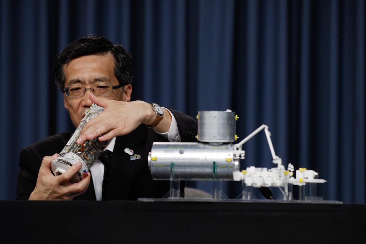 CAPE CANAVERAL, Fla. --    At a Japan Aerospace Exploration Agency briefing, Japanese Experiment Module Program Manager Yoshiyuki Hasegawa (right) explains how the Japanese Experiment Module – Pressurized Module will fit with the other segments on the International Space Station.  The final segment of the Kibo laboratory will be delivered to the space station on the STS-124 mission, which is scheduled to launch May 31. Photo credit:  NASA/Kim Shiflett