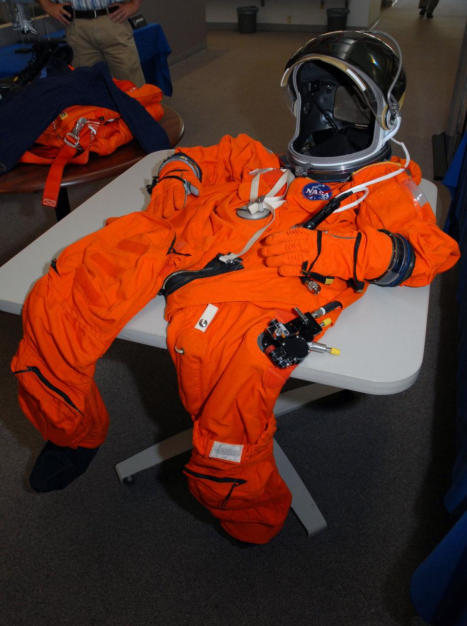 CAPE CANAVERAL, Fla. -- On a table in the NASA News Center at NASA's Kennedy Space Center, a sample launch and entry suit is laid out for the media. Shuttle Crew Escape System Manager KC Chhipwadia described the individual pieces and their importance to the safety of the shuttle crews during their missions. All the elements of the suit provide comfort plus safety elements in the event of an emergency. Photo credit: NASA/Amanda Diller