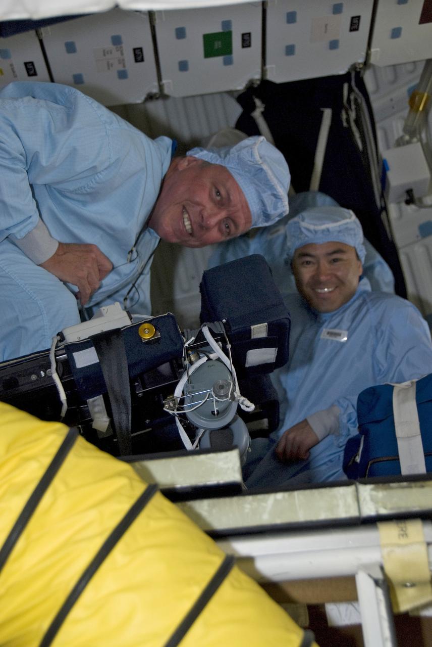 CAPE CANAVERAL, Fla. -- Members of the space shuttle Discovery's STS-124 crew inspect cables on Launch Pad 39A. From left are Mission Specialists Mike Fossum and Akihiko Hoshide, who represents the Japan Aerospace Exploration Agency. The crew is getting ready for launch at 5:02 p.m. on May 31. The STS-124 mission is the second of three flights launching components to complete the Japan Aerospace Exploration Agency's Kibo laboratory. The shuttle crew will install Kibo's large Japanese Pressurized Module and its remote manipulator system, or RMS. The 14-day flight includes three spacewalks. Photo credit: NASA/Kim Shiflett