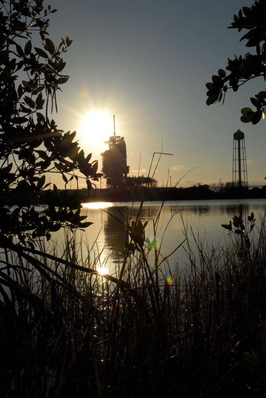 CAPE CANAVERAL, Fla. -- The setting sun backlights space shuttle Discovery on Launch Pad 39A at NASA's Kennedy Space Center just before rollback of the rotating service structure in preparation for launch on the STS-124 mission. The structure provides protected access to the shuttle for changeout and servicing of payloads at the pad. It is supported by a rotating bridge that pivots on a vertical axis on the west side of the pad's flame trench. After the RSS is rolled back, the orbiter is ready for fuel cell activation and external tank cryogenic propellant loading operations. The pad is cleared to the perimeter gate for operations to fill the external tank with about 500,000 gallons of cryogenic propellants used by the shuttle’s main engines. This is done at the pad approximately eight hours before the scheduled launch. The STS-124 mission is the second of three flights launching components to complete the Japan Aerospace Exploration Agency's Kibo laboratory. The shuttle crew will install Kibo's large Japanese Pressurized Module and its remote manipulator system, or RMS. The 14-day flight includes three spacewalks. Launch is scheduled for 5:02 p.m. May 31. Photo credit: NASA/Troy Cryder