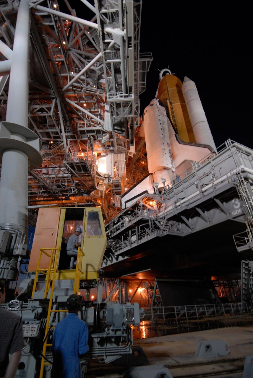 CAPE CANAVERAL, Fla. -- On Launch Pad 39A at NASA's Kennedy Space Center, the rotating service structure begins rolling on its axis to uncover space shuttle Discovery in preparation for launch on the STS-124 mission. Support for the outer end of the bridge is provided by two eight-wheel, motor-driven trucks (one is seen at bottom left) that move along circular twin rails installed flush with the pad surface. First motion was at 8:33 p.m. and rollback was complete at 9:07 p.m. The structure provides protected access to the shuttle for changeout and servicing of payloads at the pad. It is supported by a rotating bridge that pivots on a vertical axis on the west side of the pad's flame trench. After the RSS is rolled back, the orbiter is ready for fuel cell activation and external tank cryogenic propellant loading operations. The pad is cleared to the perimeter gate for operations to fill the external tank with about 500,000 gallons of cryogenic propellants used by the shuttle’s main engines. This is done at the pad approximately eight hours before the scheduled launch. The STS-124 mission is the second of three flights launching components to complete the Japan Aerospace Exploration Agency's Kibo laboratory. The shuttle crew will install Kibo's large Japanese Pressurized Module and its remote manipulator system, or RMS. The 14-day flight includes three spacewalks. Launch is scheduled for 5:02 p.m. May 31. Photo credit: NASA/Troy Cryder