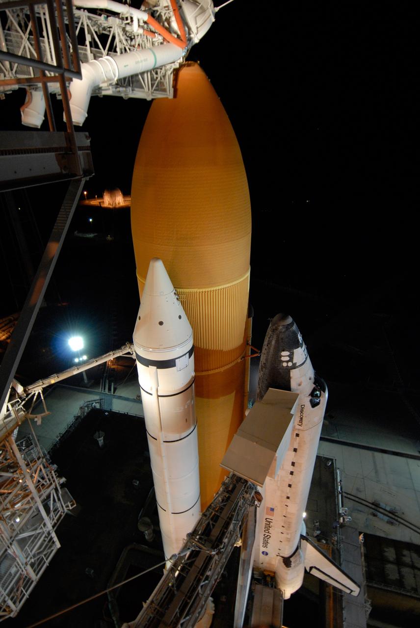 CAPE CANAVERAL, Fla. -- Bathed in lights surrounding Launch Pad 39A and its structures at NASA's Kennedy Space Center, space shuttle Discovery looks polished and ready for launch on the STS-124 mission after rollback of the rotating service structure. First motion was at 8:33 p.m. and rollback was complete at 9:07 p.m. The rotating structure provides protected access to the shuttle for changeout and servicing of payloads at the pad. It is supported by a rotating bridge that pivots on a vertical axis on the west side of the pad's flame trench. After the RSS is rolled back, the orbiter is ready for fuel cell activation and external tank cryogenic propellant loading operations. The pad is cleared to the perimeter gate for operations to fill the external tank with about 500,000 gallons of cryogenic propellants used by the shuttle’s main engines. This is done at the pad approximately eight hours before the scheduled launch. Along with the orange external tank and one of the two solid rocket boosters, the orbiter access arm is seen extended to the side of the shuttle. At the end is the White Room, which provides access into the shuttle. The STS-124 mission is the second of three flights launching components to complete the Japan Aerospace Exploration Agency's Kibo laboratory. The shuttle crew will install Kibo's large Japanese Pressurized Module and its remote manipulator system, or RMS. The 14-day flight includes three spacewalks. Launch is scheduled for 5:02 p.m. May 31. Photo credit: NASA/Troy Cryder