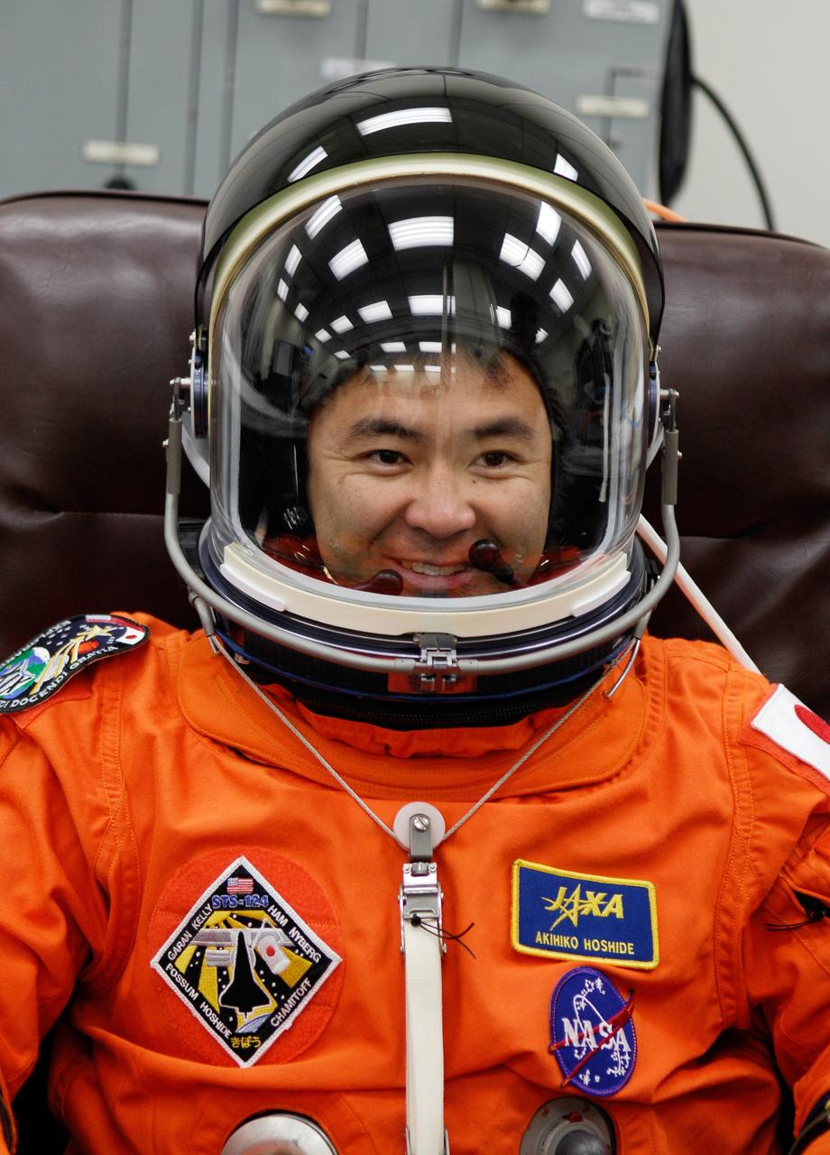 CAPE CANAVERAL, Fla. -- Crew members for space shuttle Discovery's STS-124 mission don their launch and entry suits before heading to Launch Pad 39A. Mission Specialist Akihiko Hoshide puts on his helmet to check communications. Hoshide represents the Japan Aerospace Exploration Agency. The STS-124 mission is the second of three flights launching components to complete the Japan Aerospace Exploration Agency's Kibo laboratory. The shuttle crew will install Kibo's large Japanese Pressurized Module and its remote manipulator system, or RMS. The 14-day flight includes three spacewalks. Launch is scheduled for 5:02 p.m. May 31. Photo credit: NASA/Kim Shiflett