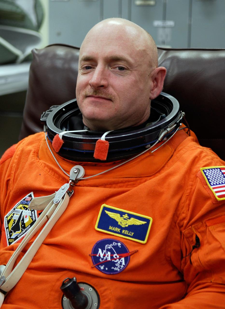 CAPE CANAVERAL, Fla. -- Crew members for space shuttle Discovery's STS-124 mission don their launch and entry suits before heading to Launch Pad 39A. Commander Mark Kelly is ready to add his helmet. The STS-124 mission is the second of three flights launching components to complete the Japan Aerospace Exploration Agency's Kibo laboratory. The shuttle crew will install Kibo's large Japanese Pressurized Module and its remote manipulator system, or RMS. The 14-day flight includes three spacewalks. Launch is scheduled for 5:02 p.m. May 31. Photo credit: NASA/Kim Shiflett