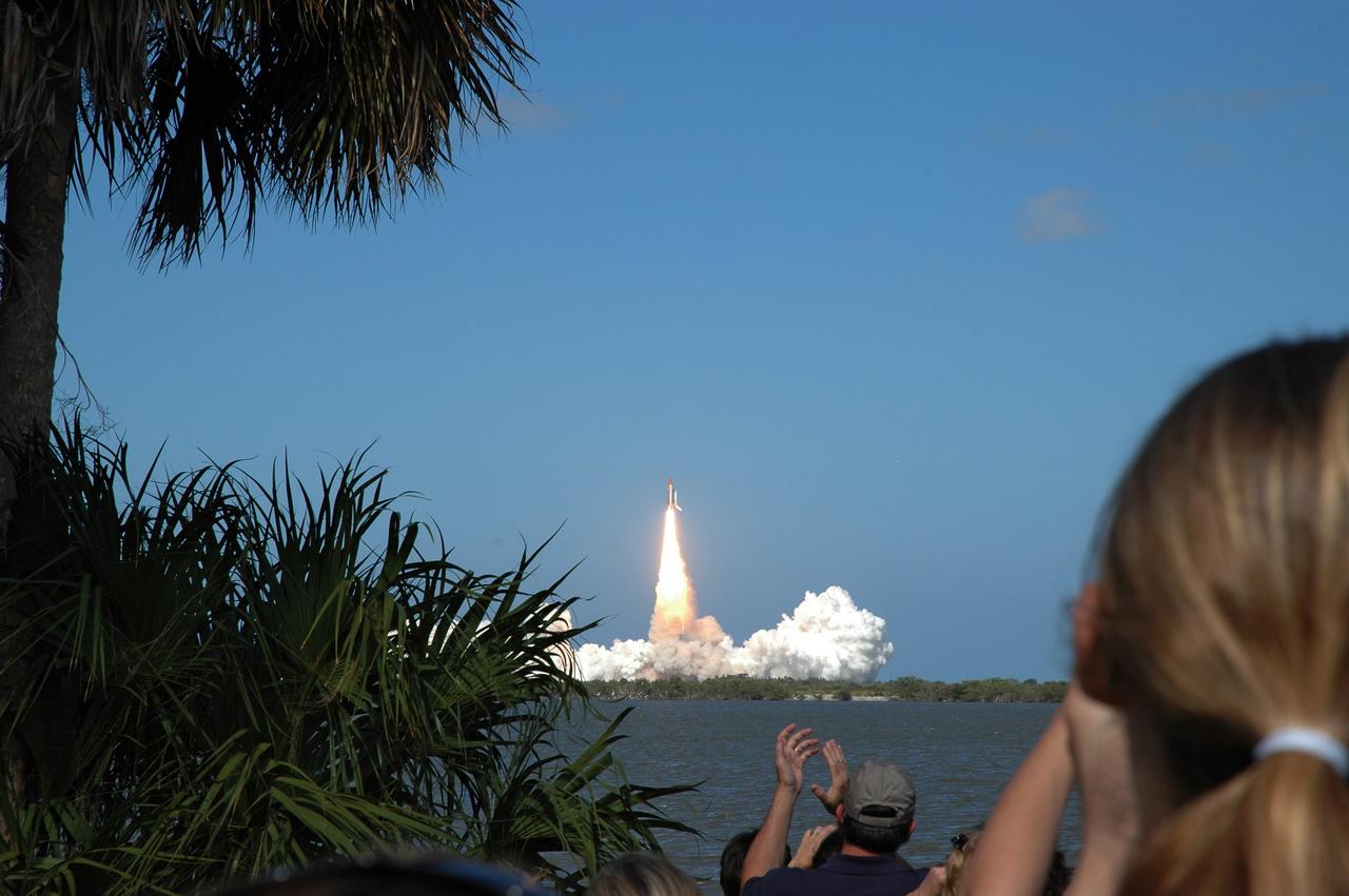 CAPE CANAVERAL, Fla. -- At the Banana River viewing site, guests applaud the picture-perfect launch of space shuttle Discovery as it leaps from the clouds of smoke below on its STS-124 mission to the International Space Station. Launch was on time at 5:02 p.m. EDT. Discovery is making its 35th flight. The STS-124 mission is the 26th in the assembly of the space station. It is the second of three flights launching components to complete the Japan Aerospace Exploration Agency's Kibo laboratory. The shuttle crew will install Kibo's large Japanese Pressurized Module and its remote manipulator system, or RMS. The 14-day flight includes three spacewalks. Photo credit: NASA/Sam Fat