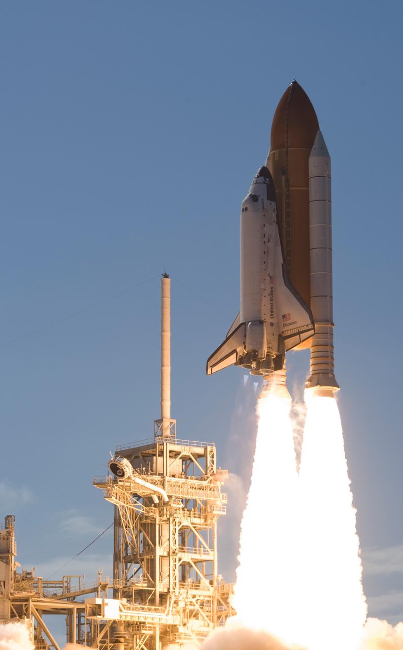 CAPE CANAVERAL, Fla. -- At NASA's Kennedy Space Center, Space shuttle Discovery leaps from Launch Pad 39A atop twin towers of flame as it races toward space on its STS-124 mission to the International Space Station. Launch was on time at 5:02 p.m. EDT. At left is the fixed service structure with the 80-foot lightning mast on top. At far left is the open rotating service structure. Discovery is making its 35th flight. The STS-124 mission is the 26th in the assembly of the space station. It is the second of three flights launching components to complete the Japan Aerospace Exploration Agency's Kibo laboratory. The shuttle crew will install Kibo's large Japanese Pressurized Module and its remote manipulator system, or RMS. The 14-day flight includes three spacewalks. Photo courtesy of Scott Andrews