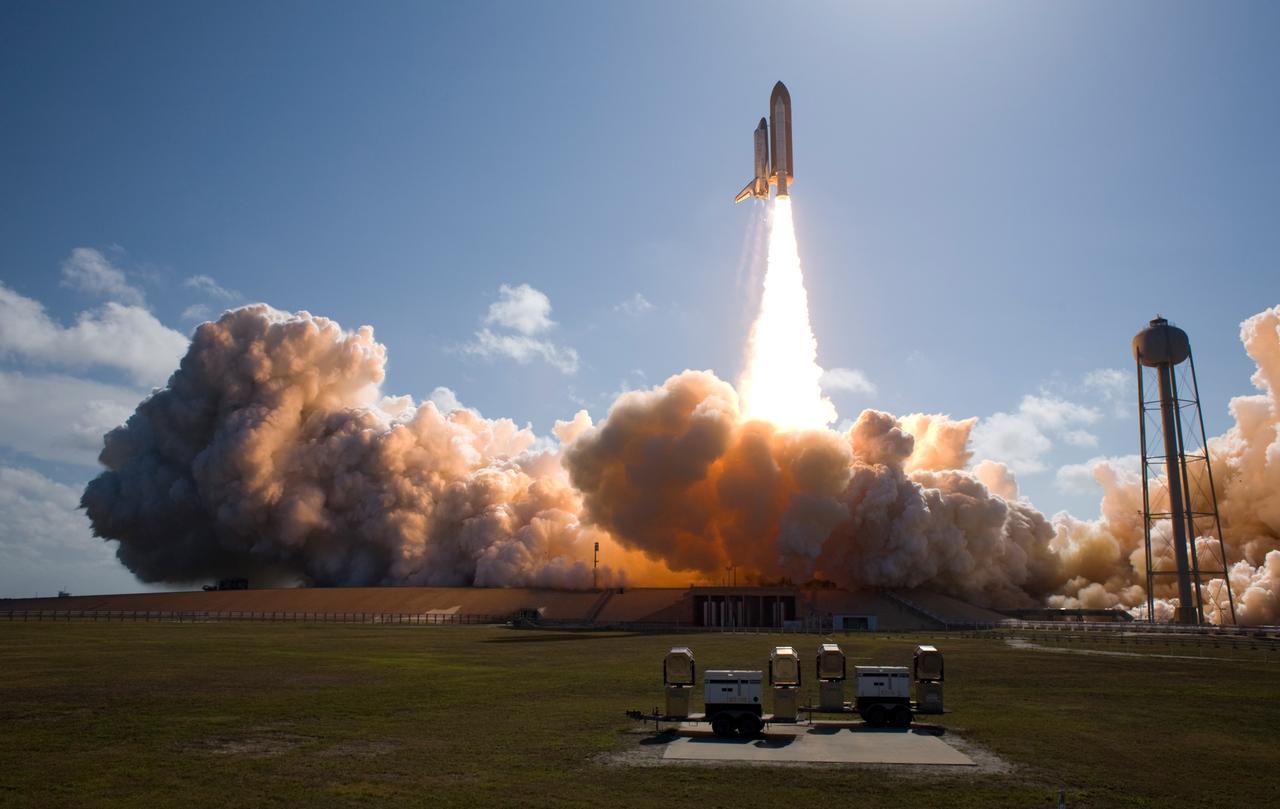 CAPE CANAVERAL, Fla. --  At NASA's Kennedy Space Center, smoke and steam billow across Launch Pad 39A as space shuttle Discovery races toward space atop twin towers of flame.  Launch was on time at 5:02 p.m. EDT. At right is the 300,000-gallon water tower that provides the water used for sound suppression on the pad during liftoff.  Discovery is making its 35th flight.  The STS-124 mission is the 26th in the assembly of the space station.  It is the second of three flights launching components to complete the Japan Aerospace Exploration Agency's Kibo laboratory.  The shuttle crew will install Kibo's large Japanese Pressurized Module and its remote manipulator system, or RMS.  The 14-day flight includes three spacewalks.  Photo courtesy of Scott Andrews