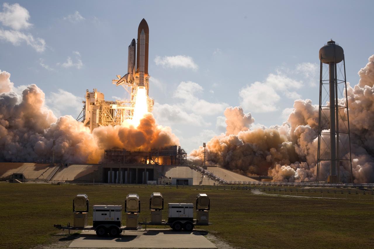CAPE CANAVERAL, Fla. --  At NASA's Kennedy Space Center, smoke and steam billow across Launch Pad 39A as space shuttle Discovery races toward space atop twin towers of flame.  Launch was on time at 5:02 p.m. EDT. Fire in the flame trench can be seen under the mobile launcher platform that straddles it.  At right is the 300,000-gallon water tower that provides the water used for sound suppression on the pad during liftoff.   Discovery is making its 35th flight.  The STS-124 mission is the 26th in the assembly of the space station.  It is the second of three flights launching components to complete the Japan Aerospace Exploration Agency's Kibo laboratory.  The shuttle crew will install Kibo's large Japanese Pressurized Module and its remote manipulator system, or RMS.  The 14-day flight includes three spacewalks.  Photo courtesy of Scott Andrews