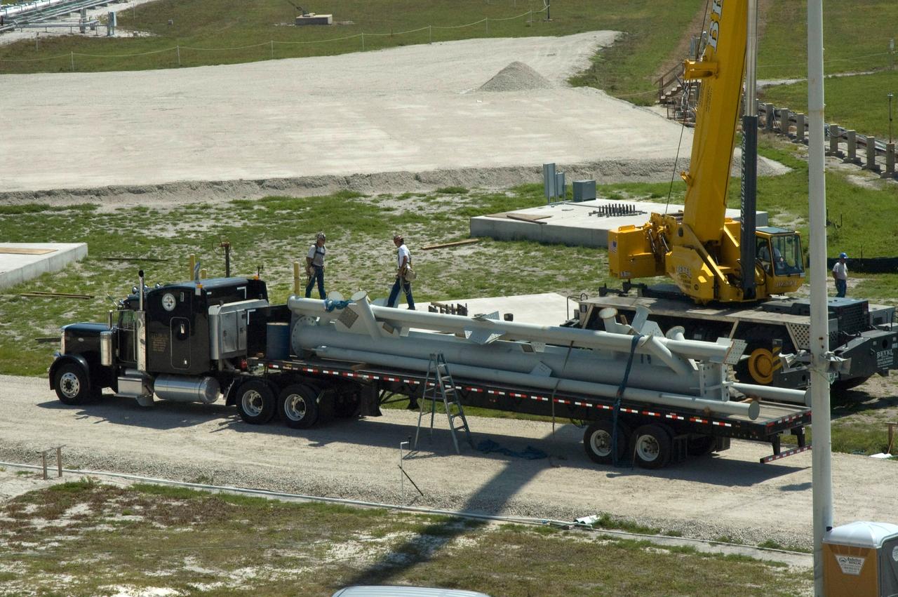 CAPE CANAVERAL, Fla. -- A lightning mast arrives on Launch Pad 39B at NASA's Kennedy Space Center for erection as part of the new lightning towers being built for the Constellation Program and Ares/Orion launches.  Pad B will be the site of the first Ares vehicle launch, including Ares I-X which is scheduled for April 2009. Photo credit: NASA/Jim Grossmann