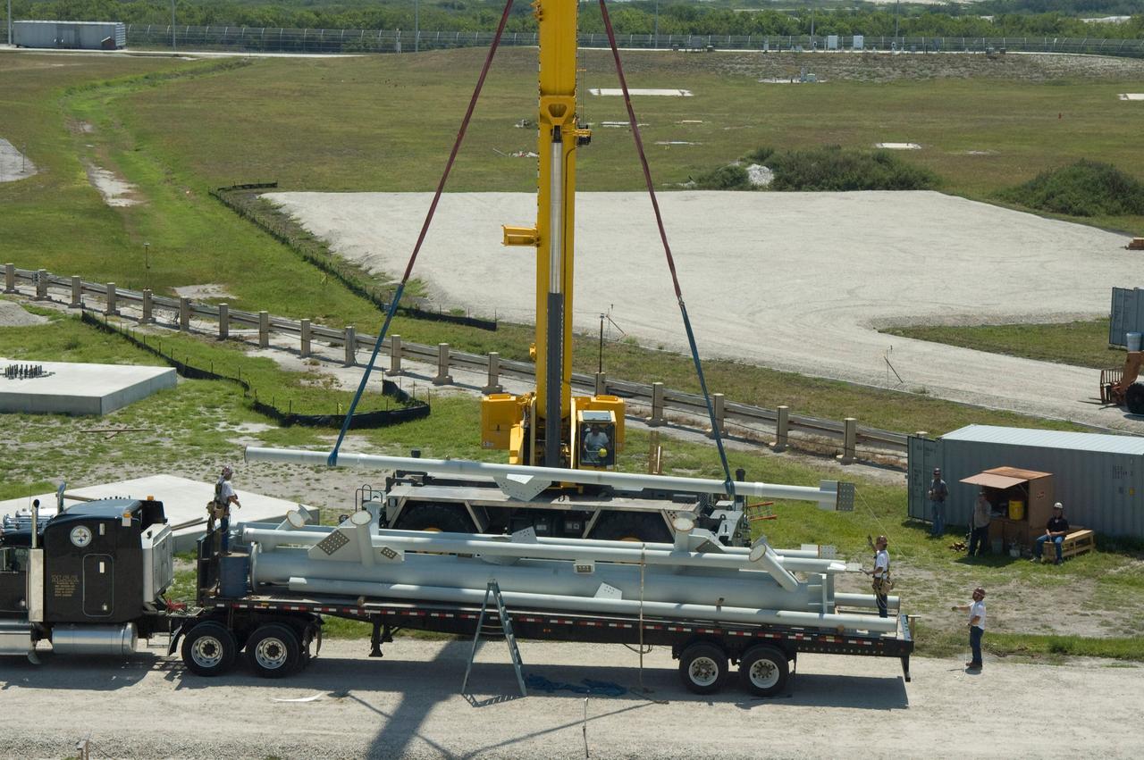 CAPE CANAVERAL, Fla. -- On Launch Pad 39B at NASA's Kennedy Space Center, a crane lifts part of the lightning mast to be erected on towers being built for the Constellation Program and Ares/Orion launches. Pad B will be the site of the first Ares vehicle launch, including Ares I-X which is scheduled for April 2009. Photo credit: NASA/Jim Grossmann