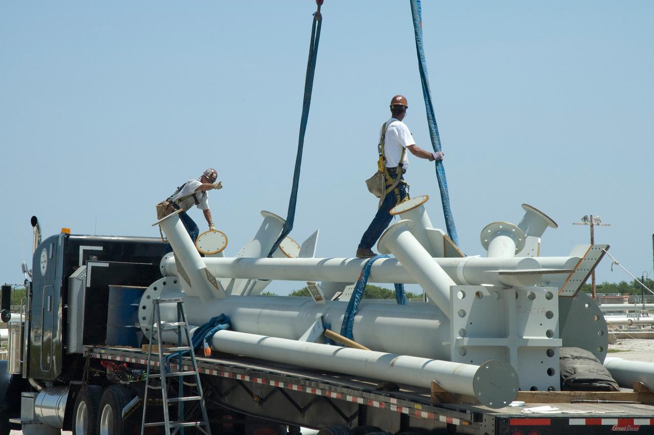 CAPE CANAVERAL, Fla. -- On Launch Pad 39B at NASA's Kennedy Space Center, workers secure straps around the lightning mast to be erected on towers being built for the Constellation Program and Ares/Orion launches. Pad B will be the site of the first Ares vehicle launch, including Ares I-X which is scheduled for April 2009. Photo credit: NASA/Jim Grossmann