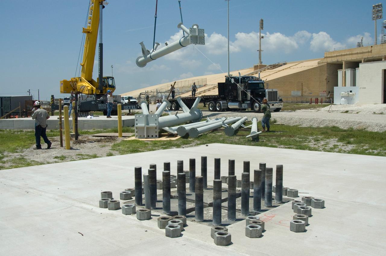 CAPE CANAVERAL, Fla. -- On Launch Pad 39B at NASA's Kennedy Space Center, a crane lifts the last part of the lightning mast to be erected on towers being built for the Constellation Program and Ares/Orion launches.  In the foreground is the base of one of the towers to be built.  Pad B will be the site of the first Ares vehicle launch, including Ares I-X which is scheduled for April 2009. Photo credit: NASA/Jim Grossmann