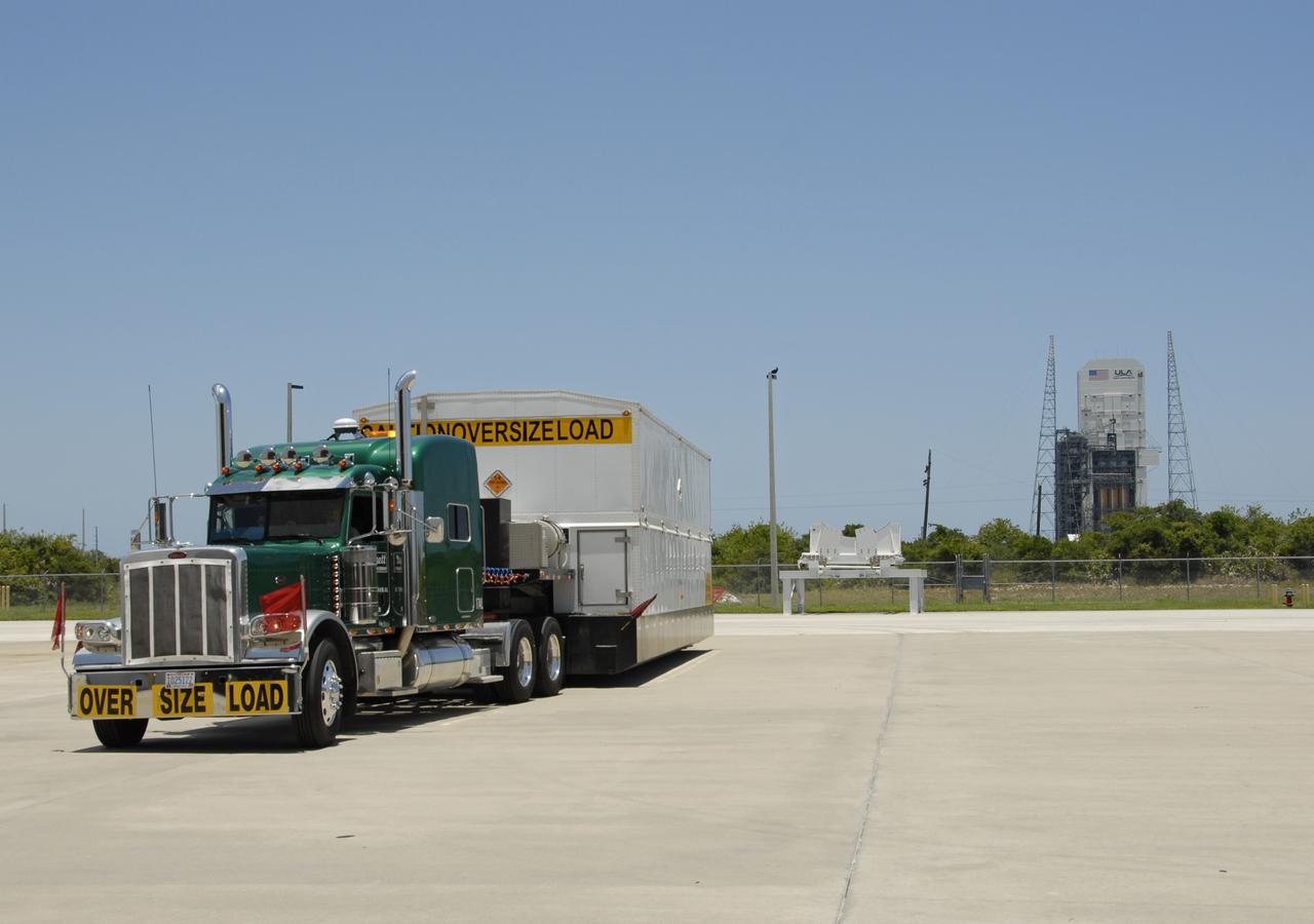 CAPE CANAVERAL, Fla. -- A truck arrives on Cape Canaveral Air Force Station to deliver its cargo, the second stage of a Delta IV rocket, to the Horizontal Integration Facility. In the background is Launch Complex 37, from where the rocket will launch. The Delta IV will launch the GOES-O satellite late in 2008. GOES – O is one of a series of Geostationary Operational Environmental Satellites. The multimission GOES series N-P will be a vital contributor to weather, solar, and space operations and science. NASA and the National Oceanic and Atmospheric Administration, or NOAA, are actively engaged in a cooperative program to expand the existing GOES system with the launch of the GOES N-P satellites. Photo credit: NASA/Dimitri Gerondidakis
