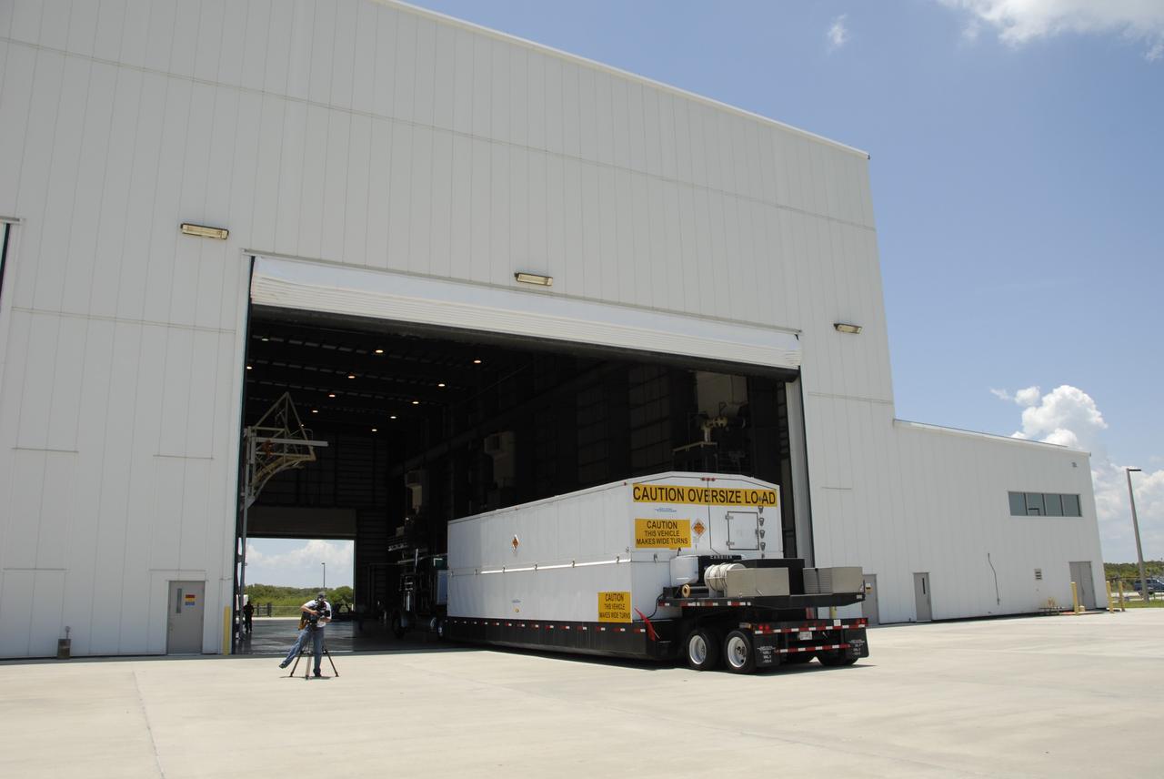 CAPE CANAVERAL, Fla. -- The truck carrying a second stage Delta IV arrives at the Horizontal Integration Facility on Cape Canaveral Air Force Station. The Delta IV will launch the GOES-O satellite from Launch Complex 37 late in 2008. GOES – O is one of a series of Geostationary Operational Environmental Satellites. The multimission GOES series N-P will be a vital contributor to weather, solar, and space operations and science. NASA and the National Oceanic and Atmospheric Administration, or NOAA, are actively engaged in a cooperative program to expand the existing GOES system with the launch of the GOES N-P satellites. Photo credit: NASA/Dimitri Gerondidakis