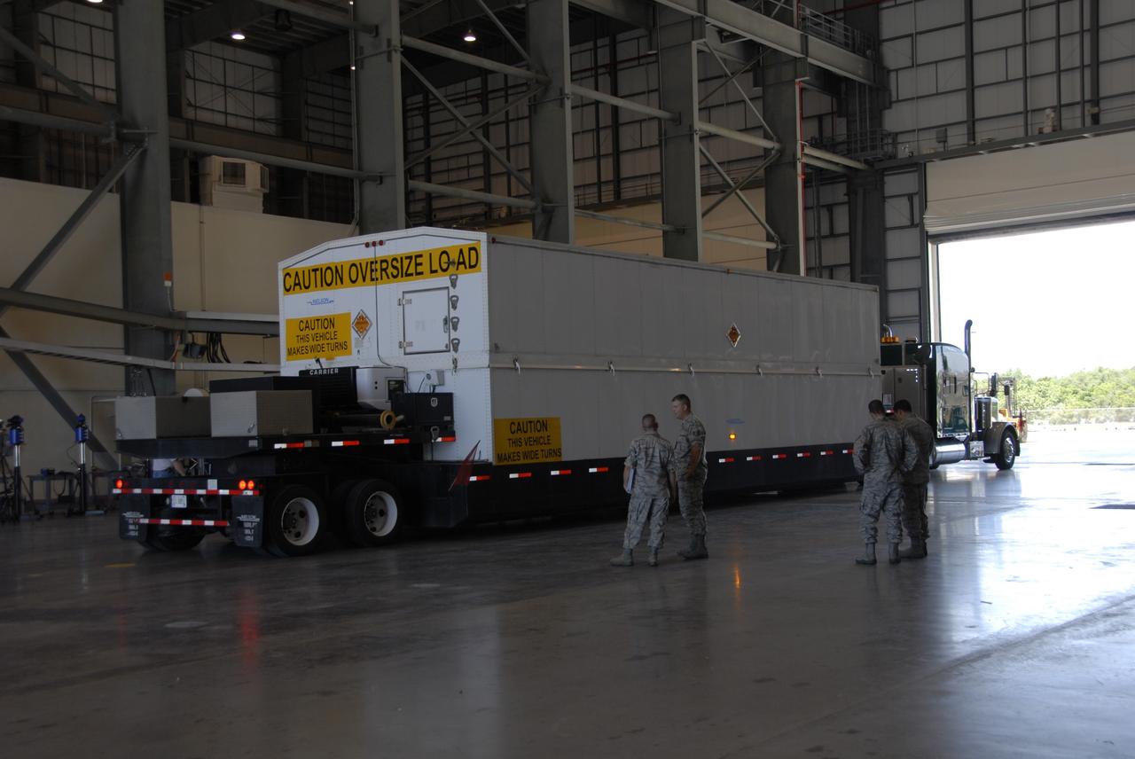 CAPE CANAVERAL, Fla. -- The truck carrying the second stage of a Delta IV rocket arrives inside the Horizontal Integration Facility on Cape Canaveral Air Force Station. The Delta IV will launch the GOES-O satellite from Launch Complex 37 late in 2008. GOES – O is one of a series of Geostationary Operational Environmental Satellites. The multimission GOES series N-P will be a vital contributor to weather, solar, and space operations and science. NASA and the National Oceanic and Atmospheric Administration, or NOAA, are actively engaged in a cooperative program to expand the existing GOES system with the launch of the GOES N-P satellites. Photo credit: NASA/Dimitri Gerondidakis