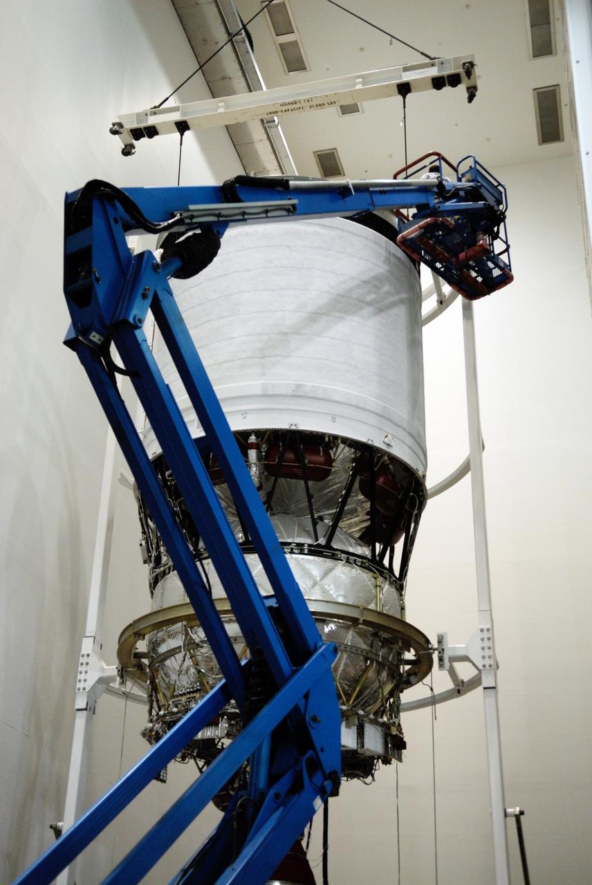 CAPE CANAVERAL, Fla. --   At Cape Canaveral Air Force Station, workers on a crane check the attachments of the sling suspending the second stage for the GOES-O Delta IV rocket.  The second stage will be moved into a work cell for processing.  GOES – O is one of a series of Geostationary Operational Environmental Satellites. The multimission GOES series N-P will be a vital contributor to weather, solar, and space operations and science. NASA and the National Oceanic and Atmospheric Administration, or NOAA, are actively engaged in a cooperative program to expand the existing GOES system with the launch of the GOES N-P satellites.  Photo credit: NASA/Kim Shiflett