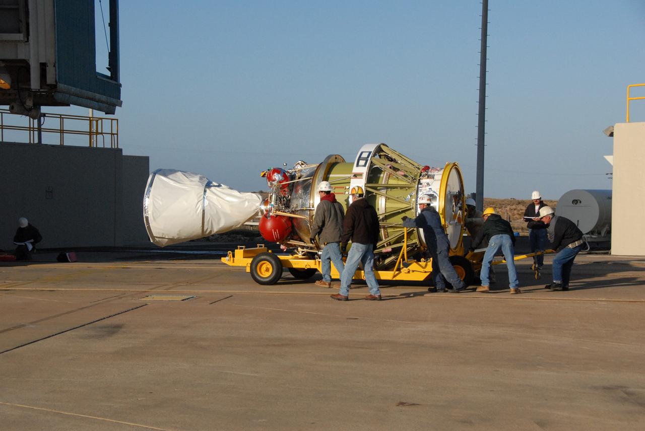 VANDENBERG AIR FORCE BASE, Calif. --  Workers on Space Launch Complex 2 at Vandenberg Air Force Base in California maneuver the transporter with the Delta II second stage into place.  It will be lifted into the mobile service tower and installed on the first stage for launch of the OSTM/Jason-2 spacecraft.  The OSTM, or Ocean Topography Mission, on the Jason-2 satellite is a follow-on to Jason-1. It will take oceanographic studies of sea surface height into an operational mode for continued climate forecasting research and science and industrial applications.  This satellite altimetry data will help determine ocean circulation, climate change and sea-level rise. OSTM is a joint effort by the National Oceanic and Atmospheric Administration, NASA, France’s Centre National d’Etudes Spatiales and the European Meteorological Satellite Organisation. OSTM/Jason-2 will be launched on June 20. Photo credit: NASA