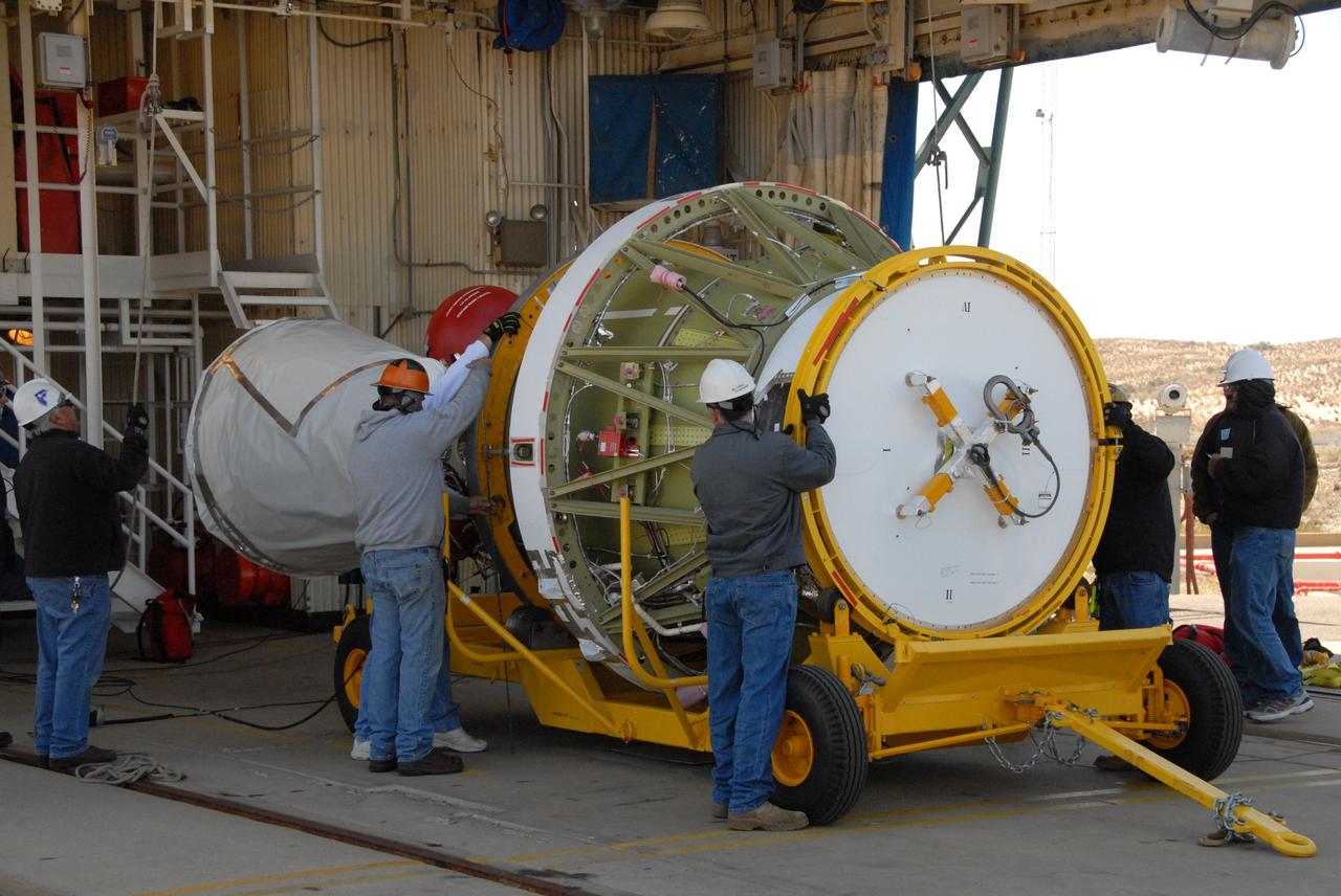 VANDENBERG AIR FORCE BASE, Calif. --  Workers on Space Launch Complex 2 at Vandenberg Air Force Base in California prepare to attach a sling crane onto the Delta II second stage.  The sling will lift the second stage into the mobile service tower for installation on the first stage for launch of the OSTM/Jason-2 spacecraft.  The OSTM, or Ocean Topography Mission, on the Jason-2 satellite is a follow-on to Jason-1. It will take oceanographic studies of sea surface height into an operational mode for continued climate forecasting research and science and industrial applications.  This satellite altimetry data will help determine ocean circulation, climate change and sea-level rise. OSTM is a joint effort by the National Oceanic and Atmospheric Administration, NASA, France’s Centre National d’Etudes Spatiales and the European Meteorological Satellite Organisation. OSTM/Jason-2 will be launched on June 20. Photo credit: NASA