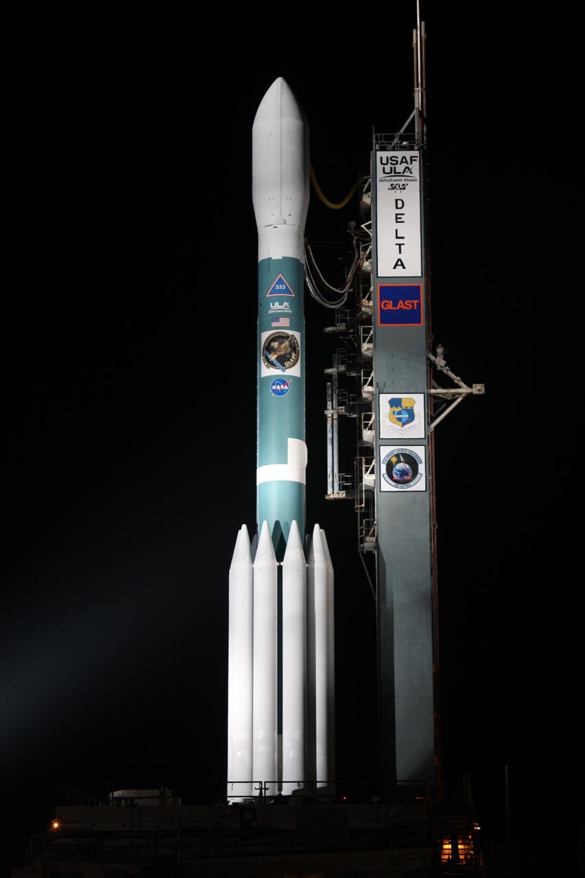 CAPE CANAVERAL, Fla.  --   NASA's Gamma-ray Large Area Space Telescope, or GLAST, spacecraft atop the Delta II rocket is spotlighted after rollback of the mobile service tower on Cape Canaveral Air Force Station's Launch Pad 17-B.  GLAST is a powerful space observatory that will explore the universe's ultimate frontier, where nature harnesses forces and energies far beyond anything possible on Earth;  probe some of science's deepest questions, such as what our universe is made of, and search for new laws of physics; explain how black holes accelerate jets of material to nearly light speed; and help crack the mystery of stupendously powerful explosions known as gamma-ray bursts.  Launch is scheduled for 11:45 a.m. June 11.  Photo credit: NASA/Dimitri Gerondidakis