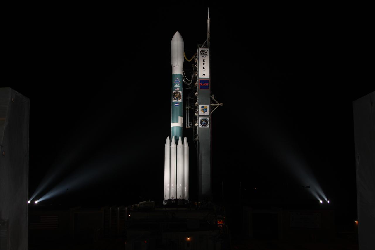 CAPE CANAVERAL, Fla.  --   NASA's Gamma-ray Large Area Space Telescope, or GLAST, spacecraft atop the Delta II rocket is spotlighted after rollback of the mobile service tower on Cape Canaveral Air Force Station's Launch Pad 17-B.  GLAST is a powerful space observatory that will explore the universe's ultimate frontier, where nature harnesses forces and energies far beyond anything possible on Earth;  probe some of science's deepest questions, such as what our universe is made of, and search for new laws of physics; explain how black holes accelerate jets of material to nearly light speed; and help crack the mystery of stupendously powerful explosions known as gamma-ray bursts.  Launch is scheduled for 11:45 a.m. June 11.  Photo credit: NASA/Dimitri Gerondidakis