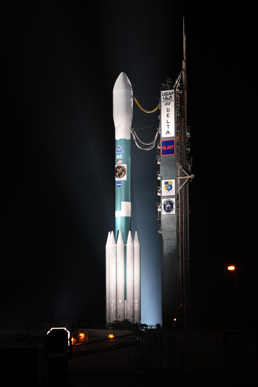 CAPE CANAVERAL, Fla.  --   NASA's Gamma-ray Large Area Space Telescope, or GLAST, spacecraft atop the Delta II rocket is spotlighted after rollback of the mobile service tower on Cape Canaveral Air Force Station's Launch Pad 17-B.  GLAST is a powerful space observatory that will explore the universe's ultimate frontier, where nature harnesses forces and energies far beyond anything possible on Earth;  probe some of science's deepest questions, such as what our universe is made of, and search for new laws of physics; explain how black holes accelerate jets of material to nearly light speed; and help crack the mystery of stupendously powerful explosions known as gamma-ray bursts.  Launch is scheduled for 11:45 a.m. June 11.  Photo credit: NASA/Dimitri Gerondidakis