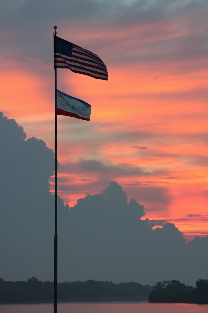 CAPE CANAVERAL, Fla.  –  A rising sun paints the sky a blazing orange behind gathering clouds over the Launch Complex 39 Area at NASA's Kennedy Space Center.  Photo credit: NASA/Dimitri Gerondidakis