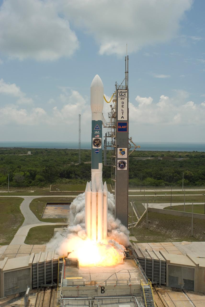CAPE CANAVERAL, Fla.  -- Smoke is generated at liftoff of the Delta II rocket with NASA's Gamma-Ray Large Area Space Telescope , or GLAST, aboard from Cape Canaveral Air Force Station's Launch Pad 17-B.  In the background can be seen the blue Atlantic Ocean between the beach and the cloud-filled sky.  Liftoff was at 12:05 p.m. EDT.  GLAST is a powerful space observatory that will explore the universe's ultimate frontier, where nature harnesses forces and energies far beyond anything possible on Earth;  probe some of science's deepest questions, such as what our universe is made of, and search for new laws of physics; explain how black holes accelerate jets of material to nearly light speed; and help crack the mystery of stupendously powerful explosions known as gamma-ray bursts.  Launch is scheduled for 11:45 a.m. June 11.  Photo credit: NASA/Jerry Cannon, Robert Murray