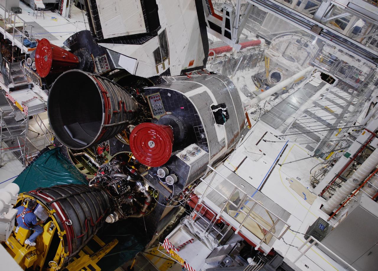 CAPE CANAVERAL, Fla. – In Orbiter Processing Facility bay No. 1, the technician on the engine installer moves a shuttle main engine toward the opening in space shuttle Atlantis. A pitch-and-yaw system helps maneuver the engine into place. Main engine No. 1 has already been installed. Atlantis is the designated vehicle for the STS-125 mission to service the Hubble Space Telescope. Launch is targeted for Oct. 8. Photo credit: NASA/Kim Shiflett