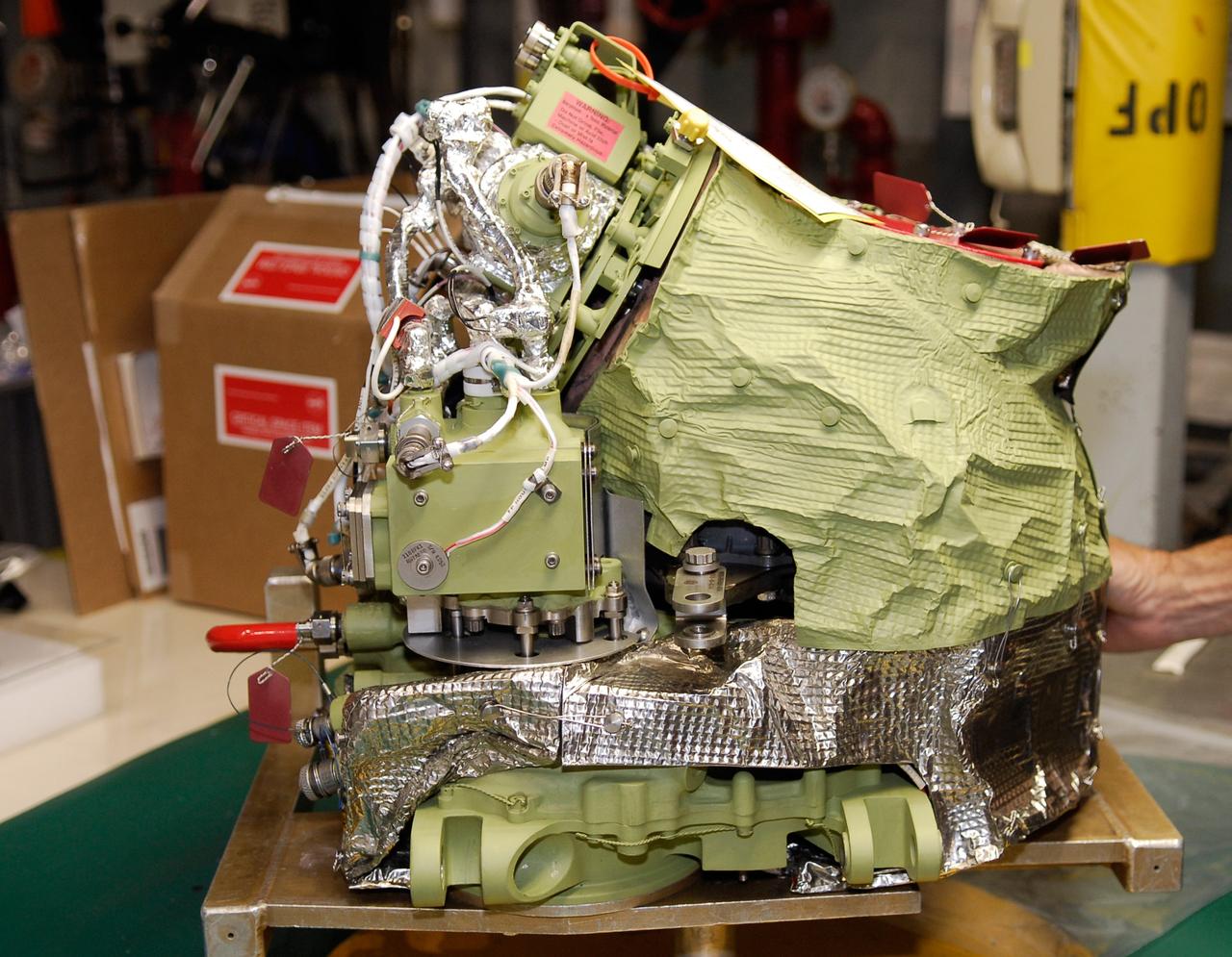 CAPE CANAVERAL, Fla. – Auxiliary power unit 3, or APU3, is ready for installation in space shuttle Endeavour for the STS-126 mission.  The auxiliary power unit is a hydrazine-fueled, turbine-driven power unit that generates mechanical shaft power to drive a hydraulic pump that produces pressure for the orbiter's hydraulic system. There are three separate APUs, three hydraulic pumps and three hydraulic systems, located in the aft fuselage of the orbiter. When the three auxiliary power units are started five minutes before lift-off, the hydraulic systems are used to position the three main engines for activation, control various propellant valves on the engines and position orbiter aerosurfaces.  The auxiliary power units are not operated after the first orbital maneuvering system thrusting period because hydraulic power is no longer required. One power unit is operated briefly one day before deorbit to support checkout of the orbiter flight control system.  One auxiliary power unit is restarted before the deorbit thrusting period. The two remaining units are started after the deorbit thrusting maneuver and operate continuously through entry, landing and landing rollout.  On STS-126, Endeavour will deliver a multi-purpose logistics module to the International Space Station. Launch is targeted for Nov. 10.  Photo credit: NASA/Kim Shiflett