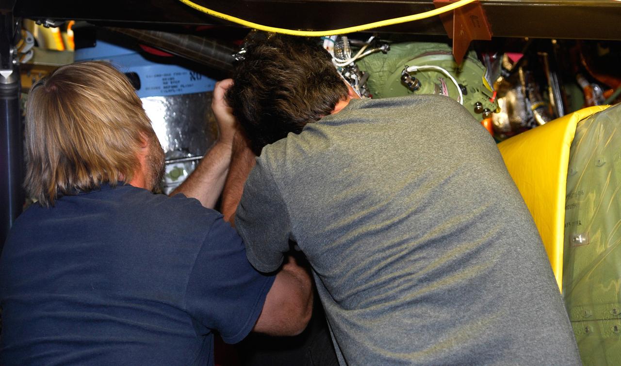 CAPE CANAVERAL, Fla. – In Orbiter Processing Facility bay No. 2, technicians install auxiliary power unit 3, or APU3, in space shuttle Endeavour for the STS-126 mission. The auxiliary power unit is a hydrazine-fueled, turbine-driven power unit that generates mechanical shaft power to drive a hydraulic pump that produces pressure for the orbiter's hydraulic system. There are three separate APUs, three hydraulic pumps and three hydraulic systems, located in the aft fuselage of the orbiter. When the three auxiliary power units are started five minutes before lift-off, the hydraulic systems are used to position the three main engines for activation, control various propellant valves on the engines and position orbiter aerosurfaces.  The auxiliary power units are not operated after the first orbital maneuvering system thrusting period because hydraulic power is no longer required. One power unit is operated briefly one day before deorbit to support checkout of the orbiter flight control system.  One auxiliary power unit is restarted before the deorbit thrusting period. The two remaining units are started after the deorbit thrusting maneuver and operate continuously through entry, landing and landing rollout.  On STS-126, Endeavour will deliver a multi-purpose logistics module to the International Space Station. Launch is targeted for Nov. 10.  Photo credit: NASA/Kim Shiflett
