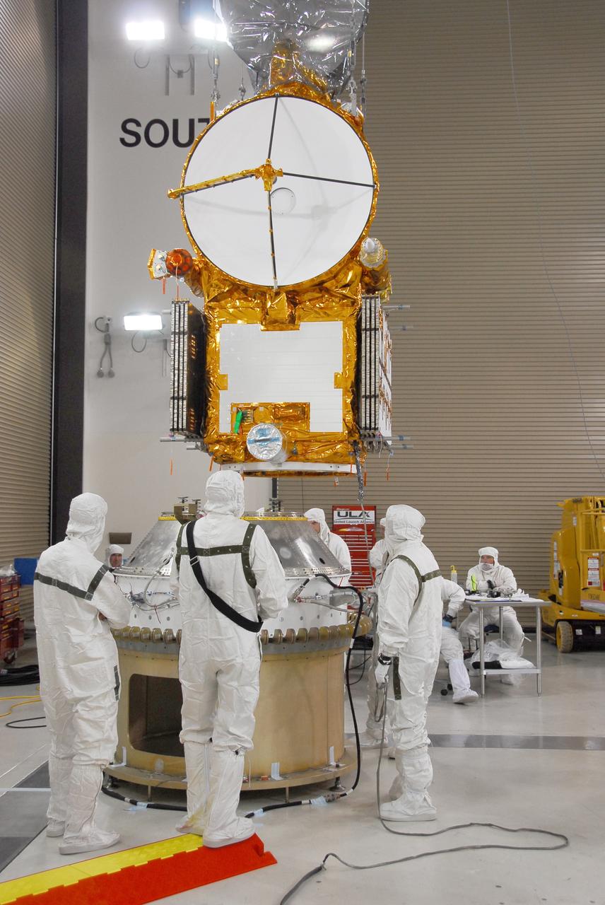 VANDENBERG AIR FORCE BASE, Calif. –  Engineers check the progress of the Ocean Surface Topography Mission, or OSTM/Jason 2, spacecraft as it moves toward the payload attach fitting, or PAF, for installation.  The PAF is the interface with the Delta II launch vehicle.  The launch of the OSTM/Jason 2 aboard a Delta II rocket is scheduled for Friday, June 20, from Vandenberg Air Force Base in California. The launch window extends from 12:46 a.m. to 12:55 a.m. PDT. The satellite will be placed in an 830-mile-high orbit at an inclination of 66 degrees after separating from the Delta II 55 minutes after liftoff.  The five primary science instruments of the Ocean Surface Topography Mission aboard the Jason 2 spacecraft are dedicated to measuring ocean surface height. These measurements will be used to evaluate and forecast climate changes and improve weather forecasting. The results also are expected to help forecasters better predict hurricane intensity. Photo credit: NASA