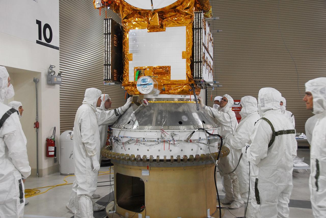 VANDENBERG AIR FORCE BASE, Calif. –   Engineers check the fit of the Ocean Surface Topography Mission, or OSTM/Jason 2, spacecraft as it is lowered onto the payload attach fitting, or PAF, for installation.  The PAF is the interface with the Delta II launch vehicle.  The launch of the OSTM/Jason 2 aboard a Delta II rocket is scheduled for Friday, June 20, from Vandenberg Air Force Base in California. The launch window extends from 12:46 a.m. to 12:55 a.m. PDT. The satellite will be placed in an 830-mile-high orbit at an inclination of 66 degrees after separating from the Delta II 55 minutes after liftoff.  The five primary science instruments of the Ocean Surface Topography Mission aboard the Jason 2 spacecraft are dedicated to measuring ocean surface height. These measurements will be used to evaluate and forecast climate changes and improve weather forecasting. The results also are expected to help forecasters better predict hurricane intensity. Photo credit: NASA