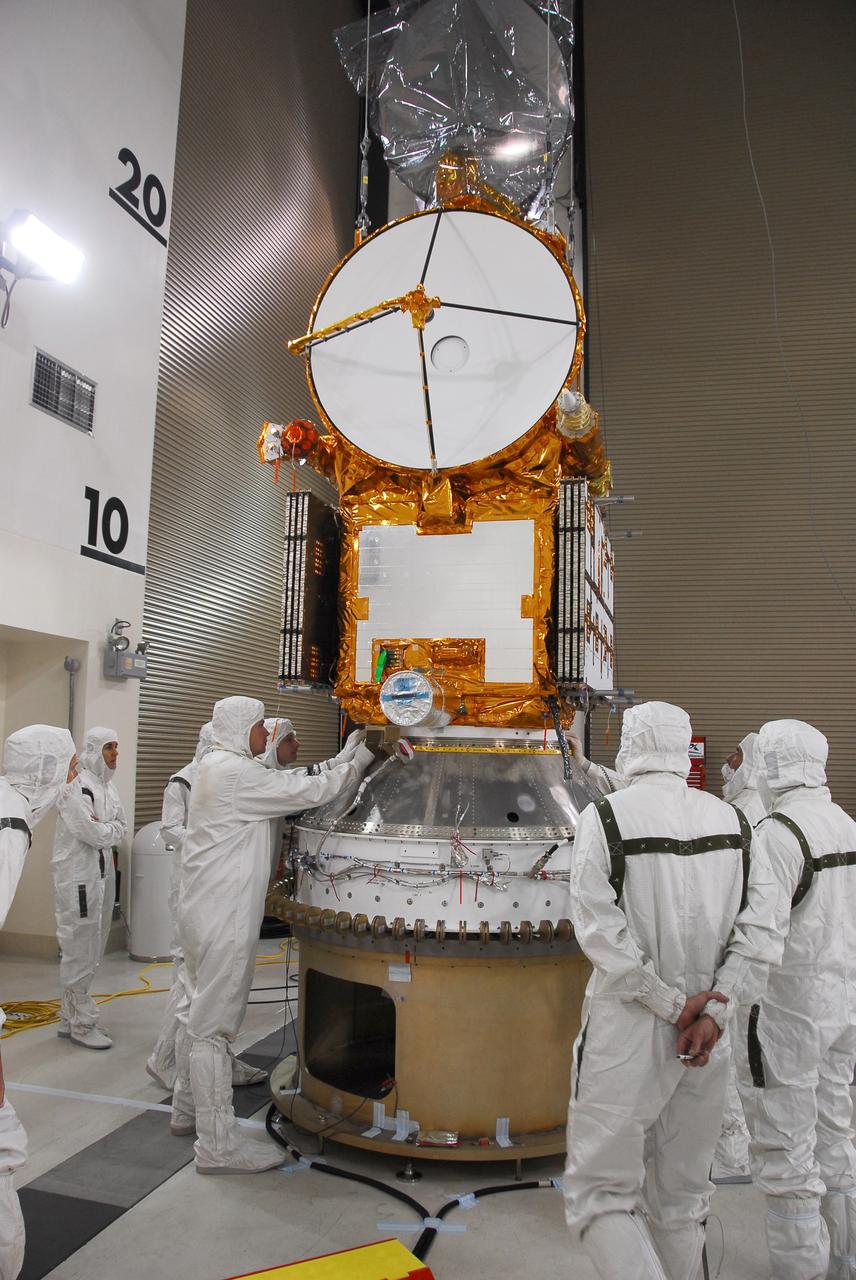 VANDENBERG AIR FORCE BASE, Calif. –   Engineers check the installation of the Ocean Surface Topography Mission, or OSTM/Jason 2, spacecraft onto the payload attach fitting, or PAF.  The PAF is the interface with the Delta II launch vehicle. The launch of the OSTM/Jason 2 aboard a Delta II rocket is scheduled for Friday, June 20, from Vandenberg Air Force Base in California. The launch window extends from 12:46 a.m. to 12:55 a.m. PDT. The satellite will be placed in an 830-mile-high orbit at an inclination of 66 degrees after separating from the Delta II 55 minutes after liftoff.  The five primary science instruments of the Ocean Surface Topography Mission aboard the Jason 2 spacecraft are dedicated to measuring ocean surface height. These measurements will be used to evaluate and forecast climate changes and improve weather forecasting. The results also are expected to help forecasters better predict hurricane intensity. Photo credit: NASA