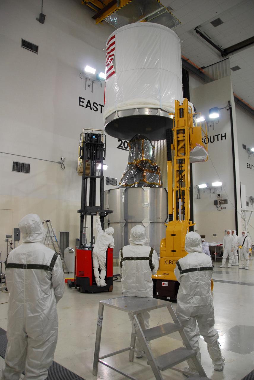 VANDENBERG AIR FORCE BASE, Calif. – The upper canister cylinder stops above the wrapped Ocean Surface Topography Mission, or OSTM/Jason 2, spacecraft. Once the canister is lowered and attached to the lower segments, the OSTM/Jason 2 will be transported to the launch pad. The launch of the OSTM/Jason 2 aboard a Delta II rocket is scheduled for Friday, June 20, from Vandenberg Air Force Base in California. The launch window extends from 12:46 a.m. to 12:55 a.m. PDT. The satellite will be placed in an 830-mile-high orbit at an inclination of 66 degrees after separating from the Delta II 55 minutes after liftoff. The five primary science instruments of the Ocean Surface Topography Mission aboard the Jason 2 spacecraft are dedicated to measuring ocean surface height. These measurements will be used to evaluate and forecast climate changes and improve weather forecasting. The results also are expected to help forecasters better predict hurricane intensity. Photo credit: NASA/Dan Liberotti