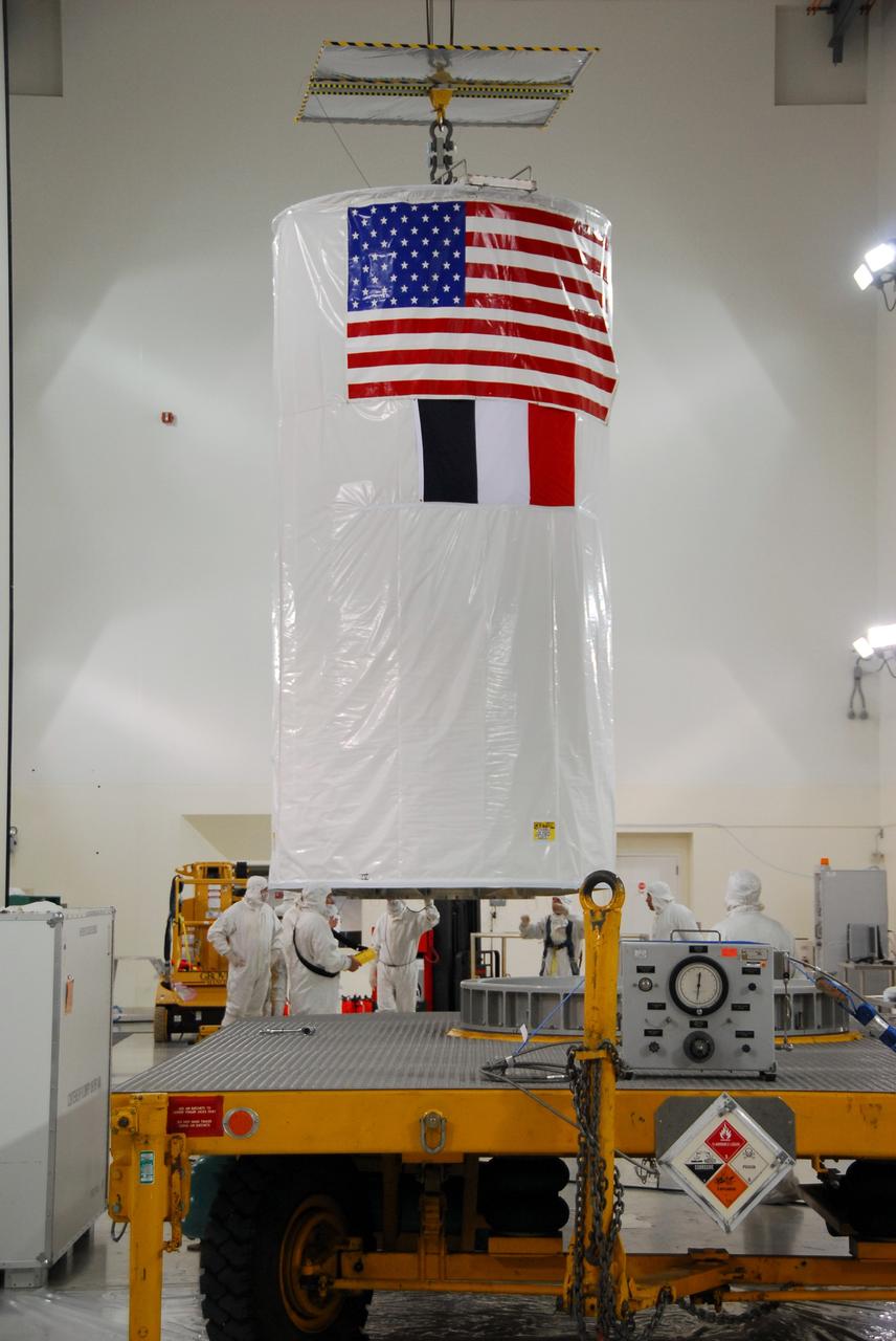 VANDENBERG AIR FORCE BASE, Calif. – An overhead crane is used to move the covered Ocean Surface Topography Mission, or OSTM/Jason 2, spacecraft onto a transporter for the trip to the launch pad. The launch of the OSTM/Jason 2 aboard a Delta II rocket is scheduled for Friday, June 20, from Vandenberg Air Force Base in California. The launch window extends from 12:46 a.m. to 12:55 a.m. PDT. The satellite will be placed in an 830-mile-high orbit at an inclination of 66 degrees after separating from the Delta II 55 minutes after liftoff. The five primary science instruments of the Ocean Surface Topography Mission aboard the Jason 2 spacecraft are dedicated to measuring ocean surface height. These measurements will be used to evaluate and forecast climate changes and improve weather forecasting. The results also are expected to help forecasters better predict hurricane intensity. Photo credit: NASA/Dan Liberotti