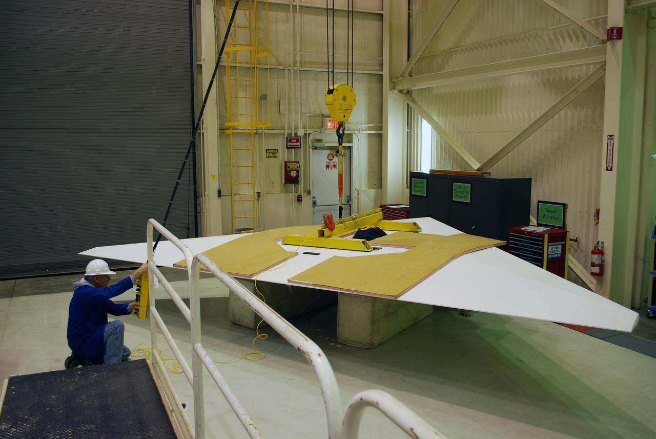 VANDENBERG AIR FORCE BASE, Calif. –  In Building 1555, the wings of the Pegasus XL launch vehicle are checked for fit. The Pegasus will launch NASA's Interstellar Boundary Explorer Mission, or IBEX, satellite from Kwajalein Island in the Marshall Islands, South Pacific.  IBEX will make the first map of the boundary between the solar system and interstellar space.  IBEX is the first mission designed to detect the edge of the solar system. As the solar wind from the sun flows out beyond Pluto, it collides with the material between the stars, forming a shock front. IBEX contains two neutral atom imagers designed to detect particles from the termination shock at the boundary between the solar system and interstellar space. IBEX also will study galactic cosmic rays, energetic particles from beyond the solar system that pose a health and safety hazard for humans exploring beyond Earth orbit. IBEX will make these observations from a highly elliptical orbit that takes it beyond the interference of the Earth's magnetosphere.  Photo credit: NASA/Randy Beaudoin