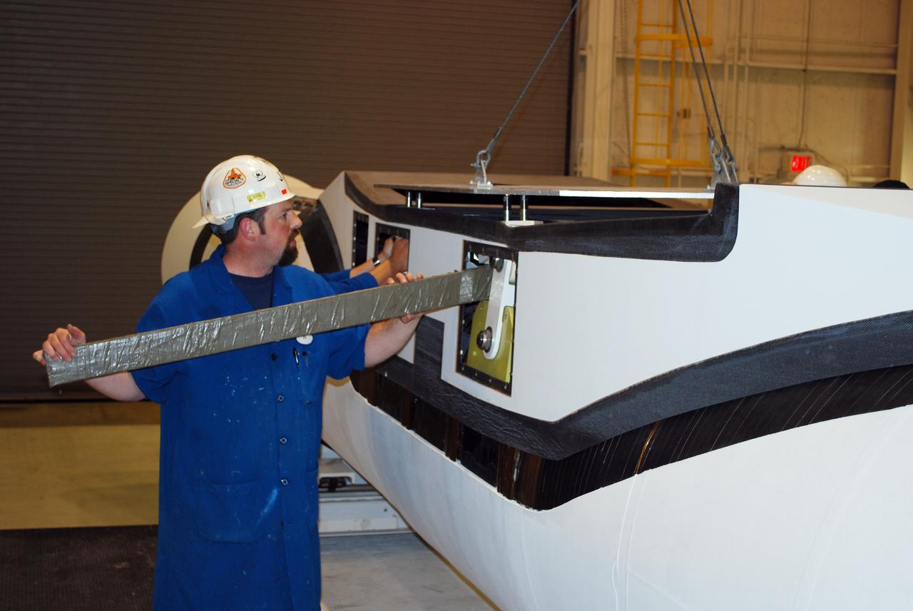 VANDENBERG AIR FORCE BASE, Calif. – In Building 1555, workers check equipment on the Pegasus XL launch vehicle. The Pegasus will launch NASA's Interstellar Boundary Explorer Mission, or IBEX, satellite from Kwajalein Island in the Marshall Islands, South Pacific. IBEX will make the first map of the boundary between the solar system and interstellar space. IBEX is the first mission designed to detect the edge of the solar system. As the solar wind from the sun flows out beyond Pluto, it collides with the material between the stars, forming a shock front. IBEX contains two neutral atom imagers designed to detect particles from the termination shock at the boundary between the solar system and interstellar space. IBEX also will study galactic cosmic rays, energetic particles from beyond the solar system that pose a health and safety hazard for humans exploring beyond Earth orbit. IBEX will make these observations from a highly elliptical orbit that takes it beyond the interference of the Earth's magnetosphere. Photo credit: NASA/Randy Beaudoin