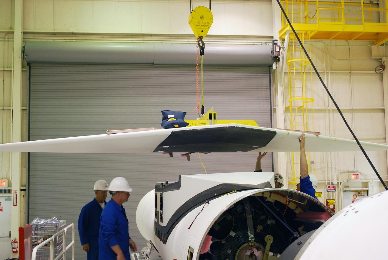 VANDENBERG AIR FORCE BASE, Calif. – In Building 1555, workers check the movement of the wing toward the Pegasus XL launch vehicle. The Pegasus will launch NASA's Interstellar Boundary Explorer Mission, or IBEX, satellite from Kwajalein Island in the Marshall Islands, South Pacific. IBEX will make the first map of the boundary between the solar system and interstellar space. IBEX is the first mission designed to detect the edge of the solar system. As the solar wind from the sun flows out beyond Pluto, it collides with the material between the stars, forming a shock front. IBEX contains two neutral atom imagers designed to detect particles from the termination shock at the boundary between the solar system and interstellar space. IBEX also will study galactic cosmic rays, energetic particles from beyond the solar system that pose a health and safety hazard for humans exploring beyond Earth orbit. IBEX will make these observations from a highly elliptical orbit that takes it beyond the interference of the Earth's magnetosphere. Photo credit: NASA/Randy Beaudoin