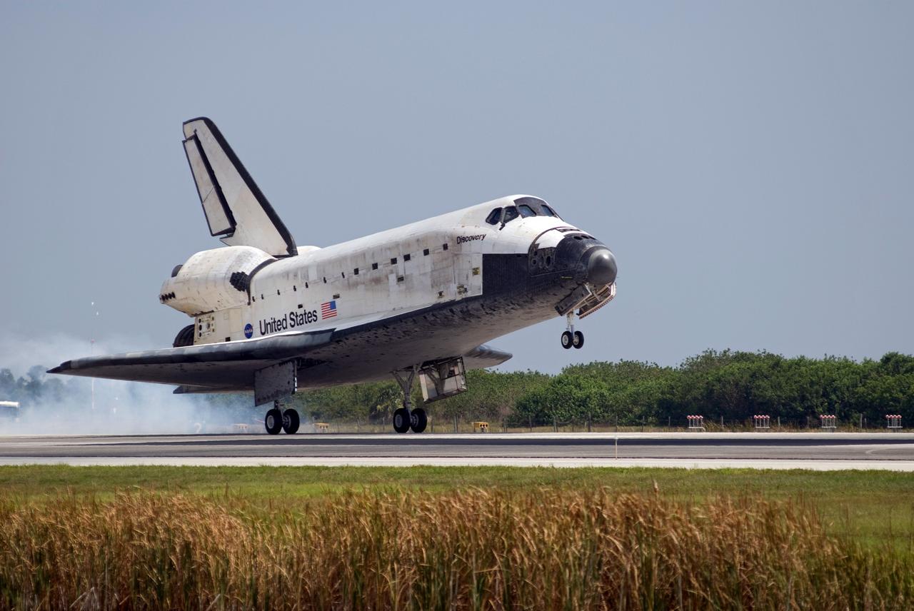 CAPE CANAVERAL, Fla.  –   Under blue skies, space shuttle Discovery kicks up dust as it touches down on Runway 15 to end the STS-124 mission, a 14-day flight to the International Space Station.  This landing was the 69th at NASA's Kennedy Space Center.  The main landing gear touched down at 11:15:19 a.m. EDT. The nose landing gear touched down at 11:15:30 a.m. and wheel stop was at 11:16:19 a.m. The mission completed 5.7 million miles. The STS-124 mission delivered the Japan Aerospace Exploration Agency's large Japanese Pressurized Module and its remote manipulator system to the space station.   Photo credit: NASA/Tom Joseph