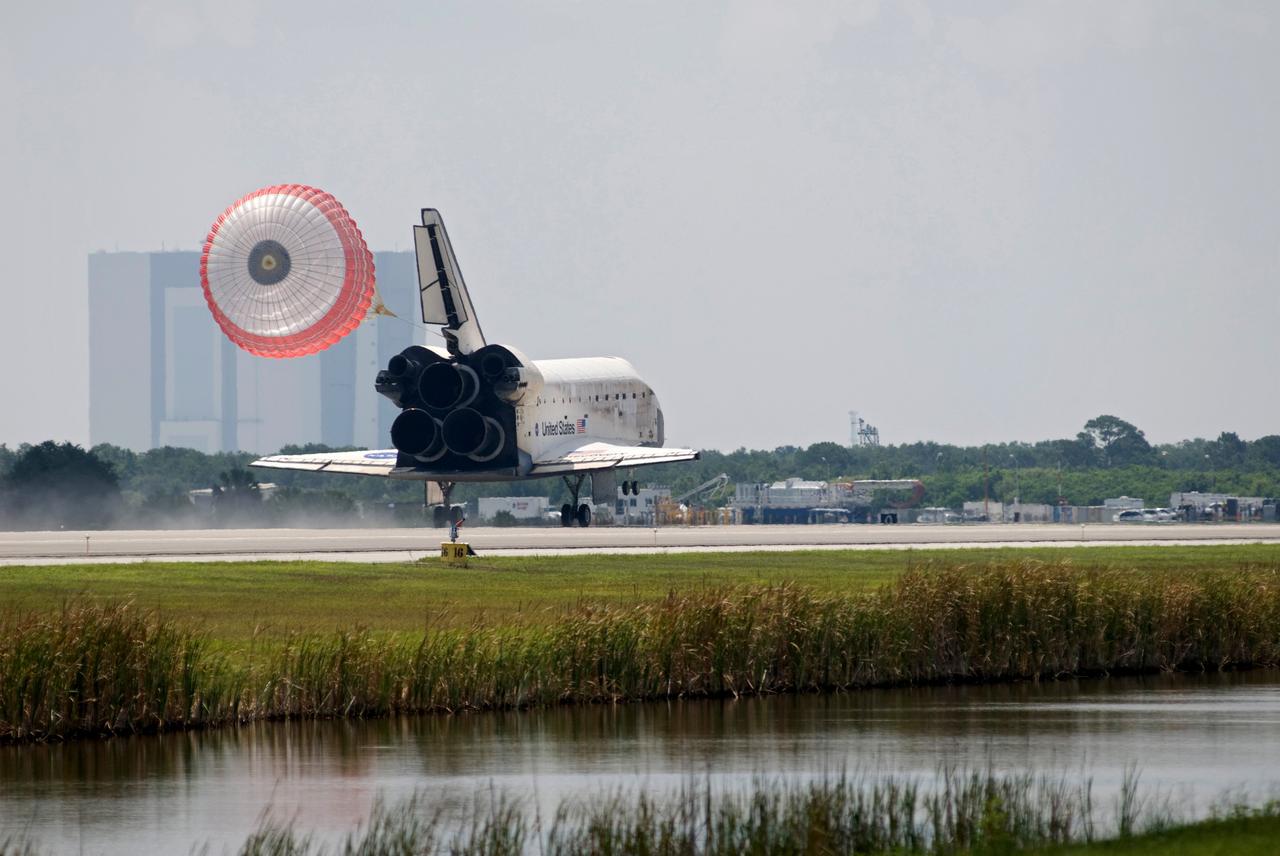 CAPE CANAVERAL, Fla. – Release of the drag chute helps slow space shuttle Discovery's landing as it touches down on Runway 15 to end the STS-124 mission, a 14-day flight to the International Space Station. This landing was the 69th at NASA's Kennedy Space Center. At right is the air traffic control tower next to the Shuttle Landing Facility. The main landing gear touched down at 11:15:19 a.m. EDT. The nose landing gear touched down at 11:15:30 a.m. and wheel stop was at 11:16:19 a.m. The mission completed 5.7 million miles. The STS-124 mission delivered the Japan Aerospace Exploration Agency's large Japanese Pressurized Module and its remote manipulator system to the space station. Photo credit: NASA/Tom Joseph