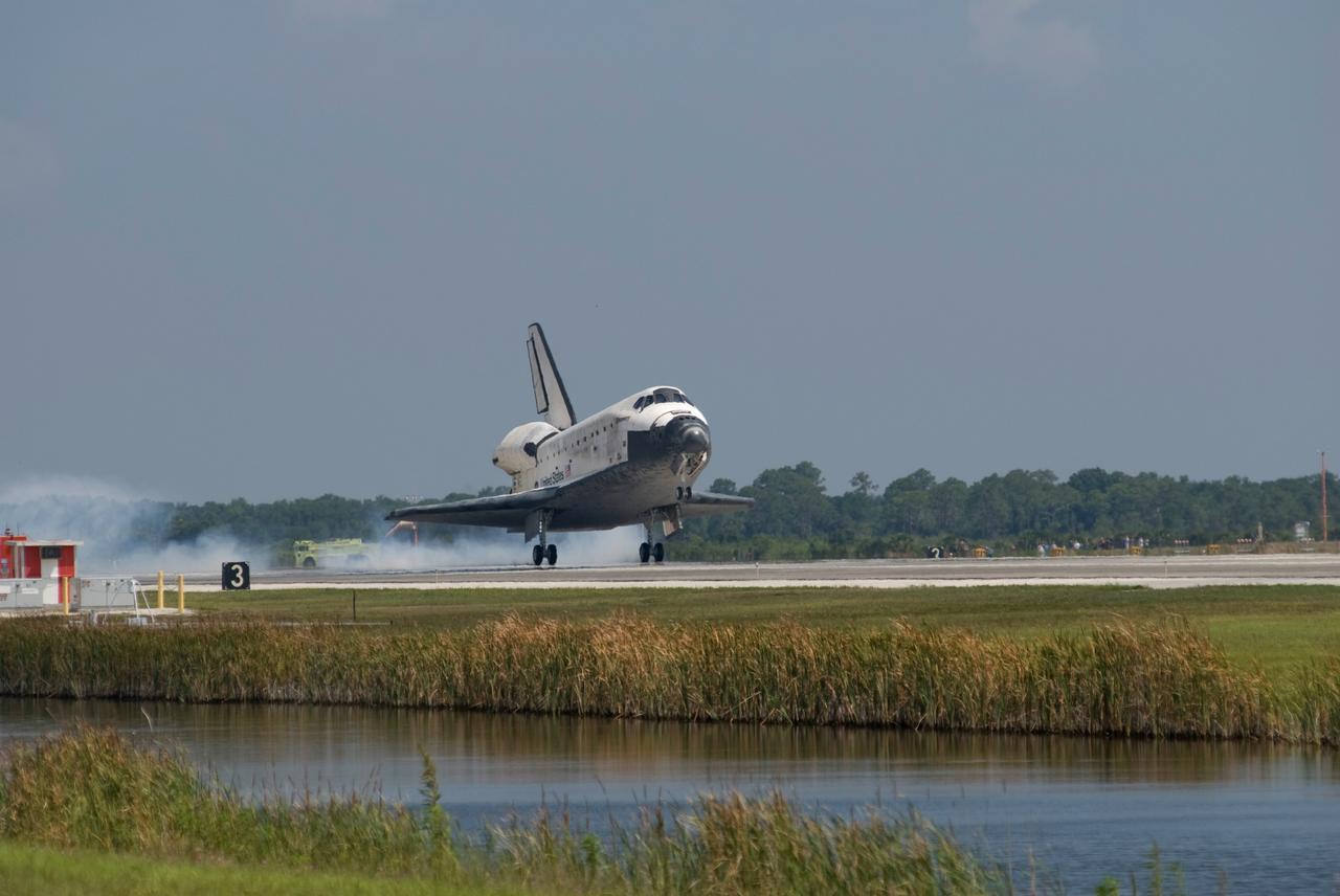 CAPE CANAVERAL, Fla. – Blue water below and blue sky above sandwich the successful landing of space shuttle Discovery on Runway 15 at NASA's Kennedy Space Center. This 69th landing at Kennedy ended the STS-124 mission, a 14-day flight to the International Space Station. The main landing gear touched down at 11:15:19 a.m. EDT. The nose landing gear touched down at 11:15:30 a.m. and wheel stop was at 11:16:19 a.m. The mission completed 5.7 million miles. The STS-124 mission delivered the Japan Aerospace Exploration Agency's large Japanese Pressurized Module and its remote manipulator system to the space station. Photo credit: NASA/Kevin O'Connell