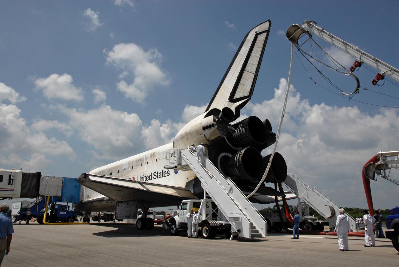 CAPE CANAVERAL, Fla.  –  After landing on Runway 15 at NASA's Kennedy Space Center, space shuttle Discovery is  purged -- providing cool and humidified air conditioning to the payload bay and other cavities to remove any residual explosive or toxic fumes – while still on the runway.  Cooling transfer to ground services occurs at about the same time, allowing onboard cooling to be shut down. When it is determined that the area in and around the orbiter is safe, the crew prepares for departure from the orbiter. The 69th landing at Kennedy ended the STS-124 mission, a 14-day flight to the International Space Station.  The main landing gear touched down at 11:15:19 a.m. EDT. The nose landing gear touched down at 11:15:30 a.m. and wheel stop was at 11:16:19 a.m. The mission completed 5.7 million miles. The STS-124 mission delivered the Japan Aerospace Exploration Agency's large Japanese Pressurized Module and its remote manipulator system to the space station.   Photo credit: NASA/Kim Shiflett