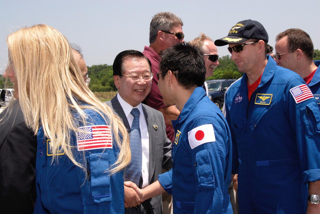 CAPE CANAVERAL, Fla. – After their successful STS-124 mission and landing on Runway 15 at NASA's Kennedy Space Center, Mission Specialists Karen Nyberg and Akihiko Hoshide, Pilot Ken Ham and Mission Specialist Ron Garan are greeted by the Japan Aerospace Exploration Agency's Director of Program Management and Integration Yuichi Yamaura and Vice President Kaoru Mamiya, Center Director Bill Parsons and Associate Administrator for Space Operations Bill Gerstenmaier. Space shuttle Discovery's main landing gear touched down at 11:15:19 a.m. EDT on Runway 15. The nose landing gear touched down at 11:15:30 a.m. and wheel stop was at 11:16:19 a.m. The mission completed 5.7 million miles. The STS-124 mission delivered the Japan Aerospace Exploration Agency's large Japanese Pressurized Module and its remote manipulator system to the space station. Photo credit: NASA/Kim Shiflett