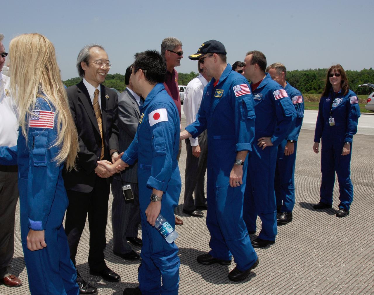 CAPE CANAVERAL, Fla. – After their successful STS-124 mission and landing on Runway 15 at NASA's Kennedy Space Center, Mission Specialists Karen Nyberg and Akihiko Hoshide, Pilot Ken Ham and Mission Specialist Ron Garan are greeted by the Japan Aerospace Exploration Agency's Director of Program Management and Integration Yuichi Yamaura and Vice President Kaoru Mamiya, Center Director Bill Parsons and Associate Administrator for Space Operations Bill Gerstenmaier. Following Garan is Chief of the Astronaut Corps Stephen Lindsay and astronaut Janet Kavandi. Space shuttle Discovery's main landing gear touched down at 11:15:19 a.m. EDT on Runway 15. The nose landing gear touched down at 11:15:30 a.m. and wheel stop was at 11:16:19 a.m. The mission completed 5.7 million miles. The STS-124 mission delivered the Japan Aerospace Exploration Agency's large Japanese Pressurized Module and its remote manipulator system to the space station. Photo credit: NASA/Kim Shiflett