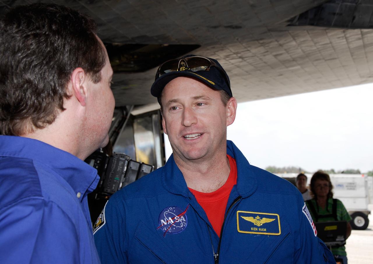 CAPE CANAVERAL, Fla. – STS-124 Pilot Ken Ham joins in the traditional walk-around under the shuttle after landing. The STS-124 mission ended with space shuttle Discovery's landing on Runway 15 at NASA's Kennedy Space Center, ending a 14-day mission to the International Space Station. Discovery's main landing gear touched down at 11:15:19 a.m. EDT on Runway 15. The nose landing gear touched down at 11:15:30 a.m. and wheel stop was at 11:16:19 a.m. The mission completed 5.7 million miles. The STS-124 mission delivered the Japan Aerospace Exploration Agency's large Japanese Pressurized Module and its remote manipulator system to the space station. Photo credit: NASA/Kim Shiflett