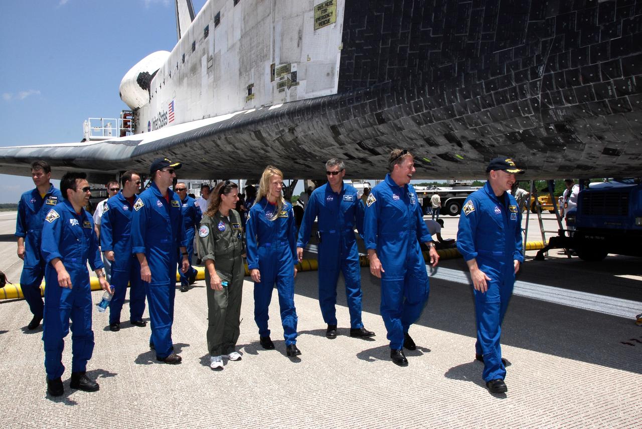 CAPE CANAVERAL, Fla. – The STS-124 mission crew members finish their traditional walk-around space shuttle Discovery after landing on Runway 15 at NASA's Kennedy Space Center, to end a 14-day mission to the International Space Station. At left are Mission Specialists Akihiko Hoshide and Ron Garan and Pilot Ken Ham. At center is Mission Specialist KarenNyberg. At right are Mission Specialist Mike Fossum and Commander Mark Kelly. The STS-124 mission ended with Discovery's landing on Runway 15 at NASA's Kennedy Space Center, ending a 14-day mission to the International Space Station. Discovery's main landing gear touched down at 11:15:19 a.m. EDT on Runway 15. The nose landing gear touched down at 11:15:30 a.m. and wheel stop was at 11:16:19 a.m. The mission completed 5.7 million miles. The STS-124 mission delivered the Japan Aerospace Exploration Agency's large Japanese Pressurized Module and its remote manipulator system to the space station. Photo credit: NASA/Kim Shiflett